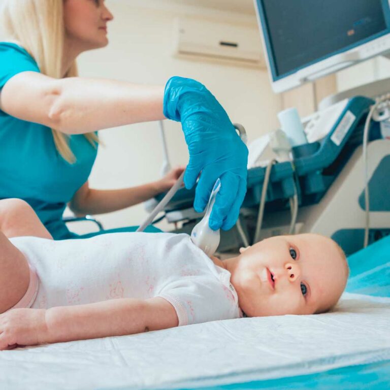 Doctor monitoring baby in hospital