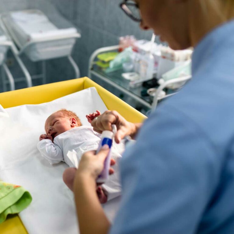 Nurse working with baby in hospital